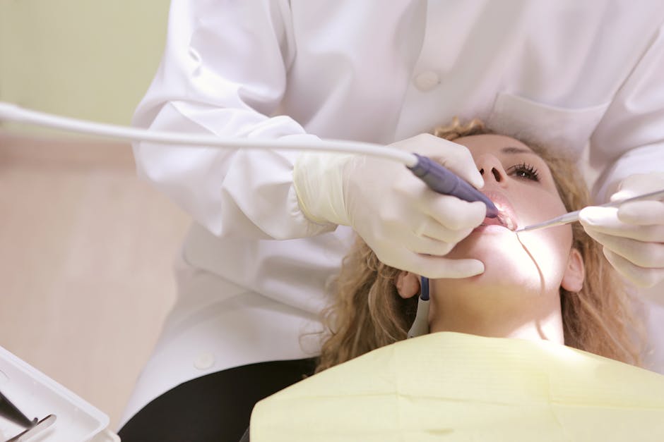 dental hygienist removing plaque - plaque cleaning cost